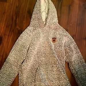 A warm fluffy sweater. It says size small but fits medium.